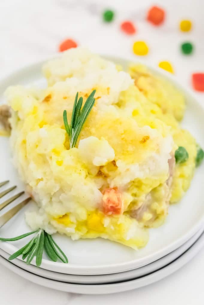 Chicken Shepherd's Pie - Not your mama's Shepherd Pie! This version is made with a creamy curry sauce that is out of this world. Topped with a heavenly layer of mashed potatoes and Parmesan cheese, this comfort food recipe will not last long. Mmm good.