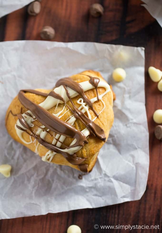 Nutella Hearts - Smooth, creamy Nutella nestled inside a buttery heart-shaped croissant with drizzled milk and white chocolate on top. This Valentine's Day dessert is sublime!