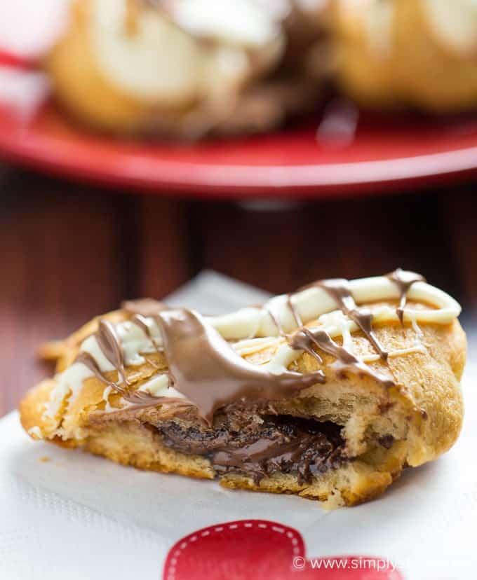 Nutella Hearts - Smooth, creamy Nutella nestled inside a buttery heart-shaped croissant with drizzled milk and white chocolate on top. This Valentine's Day dessert is sublime!
