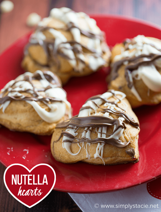 Nutella Hearts - Smooth, creamy Nutella nestled inside a buttery heart-shaped croissant with drizzled milk and white chocolate on top. This Valentine's Day dessert is sublime!