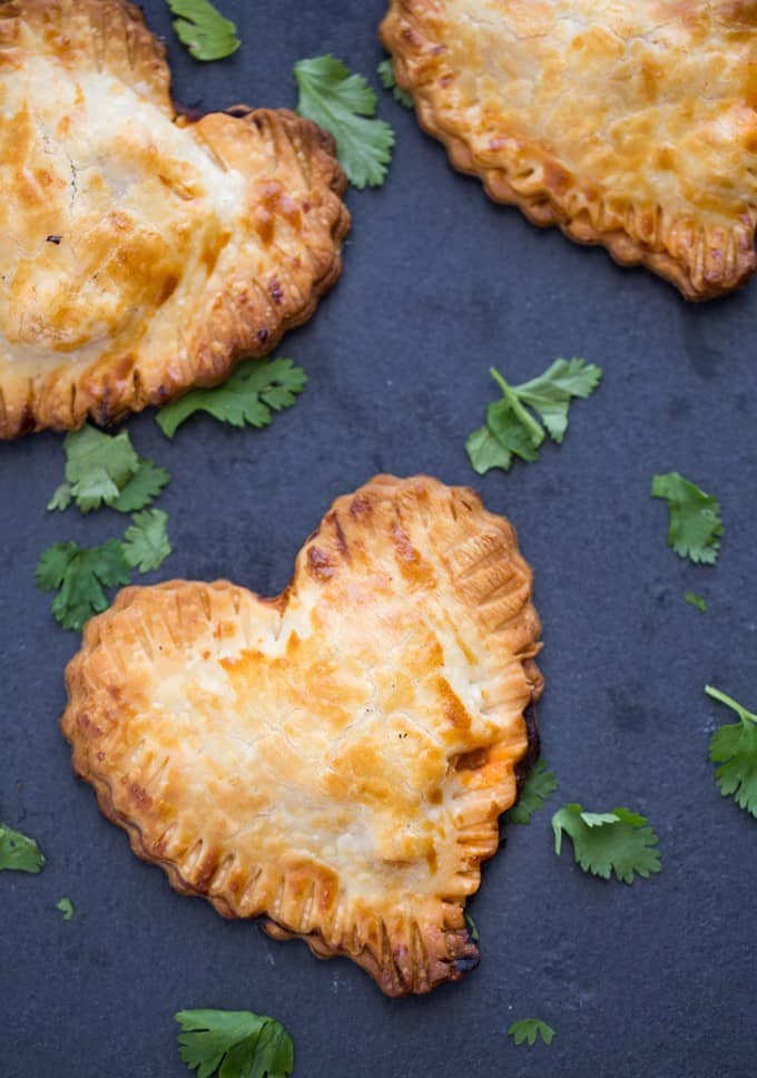 Butter Chicken Hand Pies - The best homemade Valentine's Day dinner ever! Make these heart pies with love and be done in 40 minutes flat. Creamy, flavourful Butter Chicken is stuffed inside a golden, flaky heart shaped crust! 