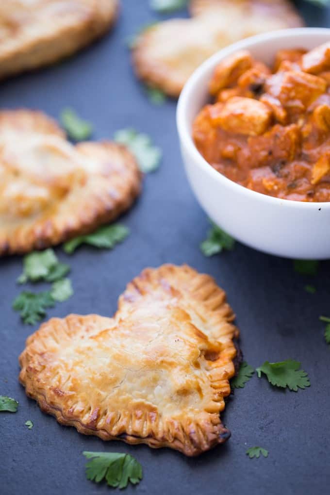 Butter Chicken Hand Pies - The best homemade Valentine's Day dinner ever! Make these heart pies with love and be done in 40 minutes flat. Creamy, flavourful Butter Chicken is stuffed inside a golden, flaky heart shaped crust! 