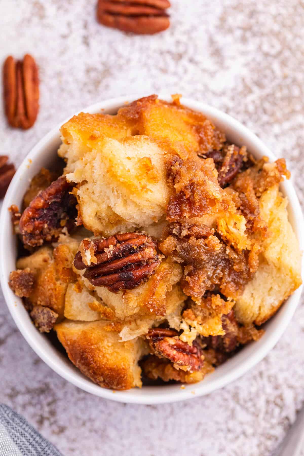 Pecan butter tart buns in a white bowl.