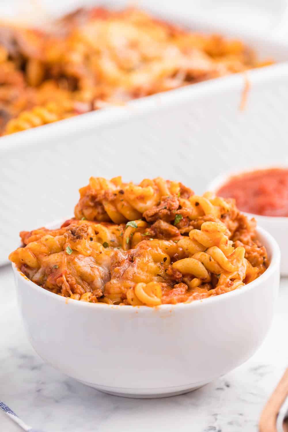 Meatzza Casserole - This crowd pleasing casserole recipe is packed with four kinds of meat, pizza sauce, veggies and oohey gooey cheese!