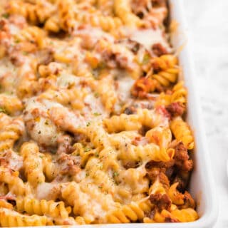 Meatzza Casserole - This crowd pleasing casserole recipe is packed with four kinds of meat, pizza sauce, veggies and oohey gooey cheese!