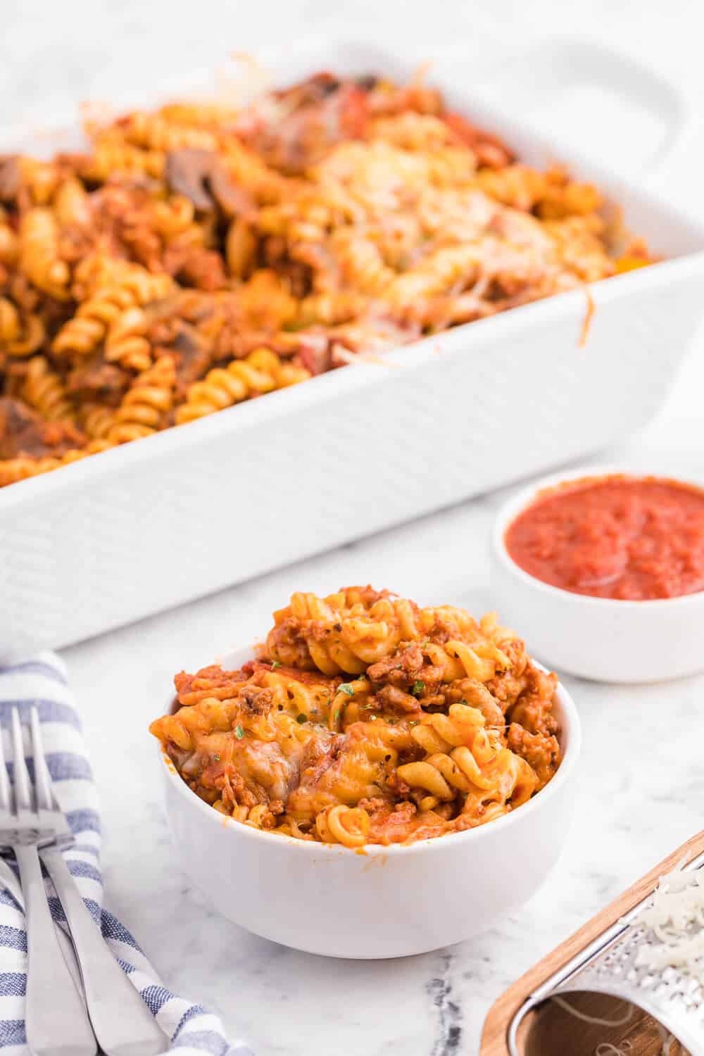 Meatzza Casserole - This crowd pleasing casserole recipe is packed with four kinds of meat, pizza sauce, veggies and oohey gooey cheese!