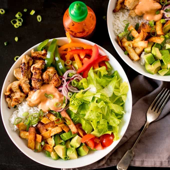 Tex Mex Lunch Bowl on a dark surface with a napkin and fork.