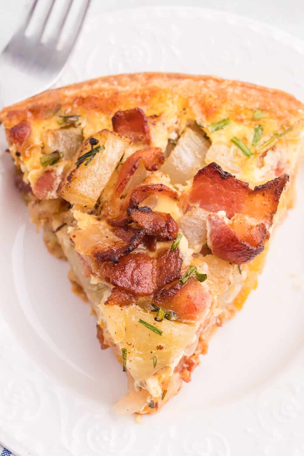 Bacon and Potato Quiche - Perfect for a St. Patrick's day brunch! A creamy, cheesy filling packed with hearty potatoes, bacon and fresh herbs.