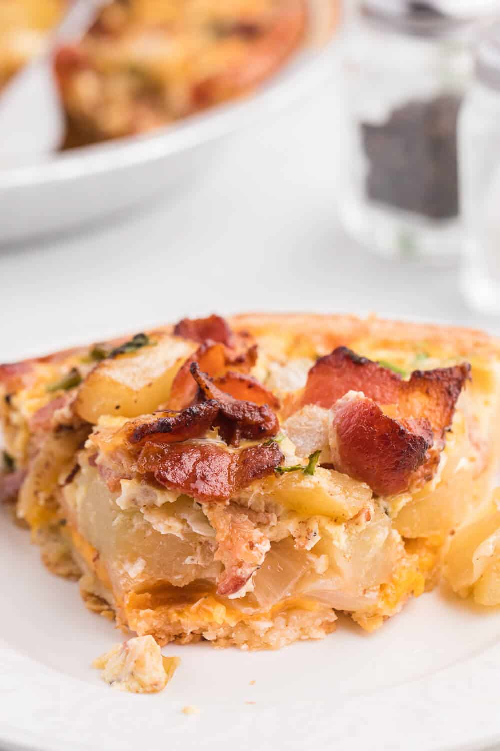 Bacon and Potato Quiche - Perfect for a St. Patrick's day brunch! A creamy, cheesy filling packed with hearty potatoes, bacon and fresh herbs.