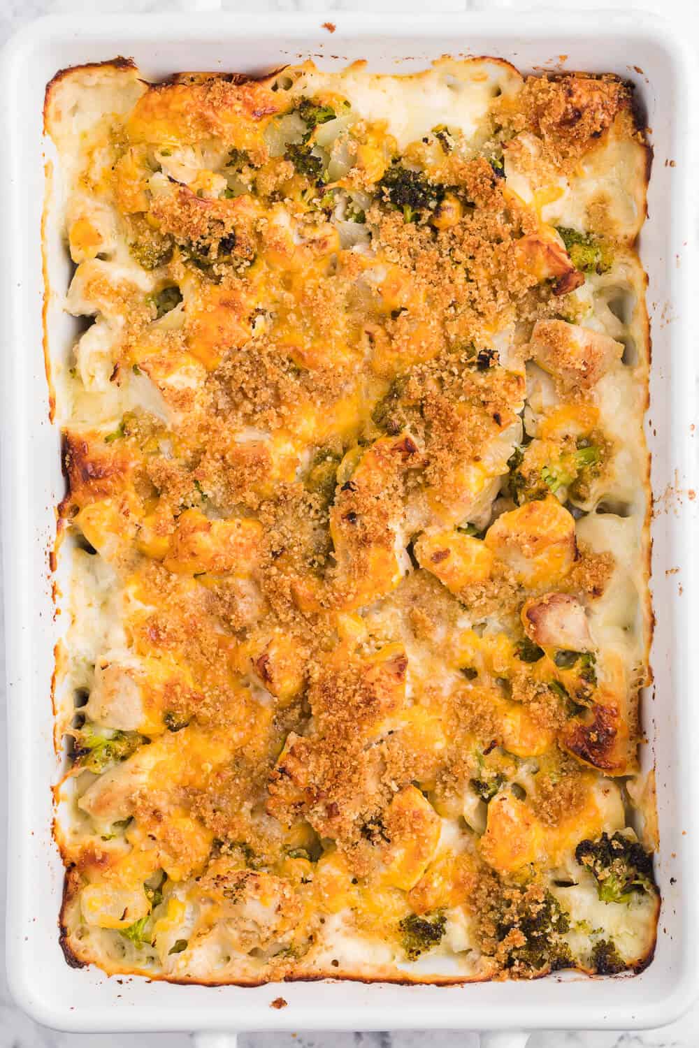 Chicken broccoli biscuit bake in a white casserole dish.