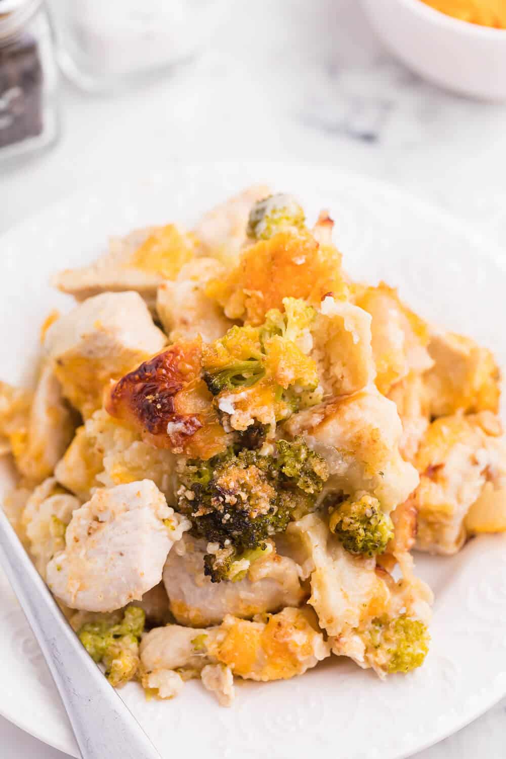 A serving of chicken broccoli biscuit bake on a white plate.