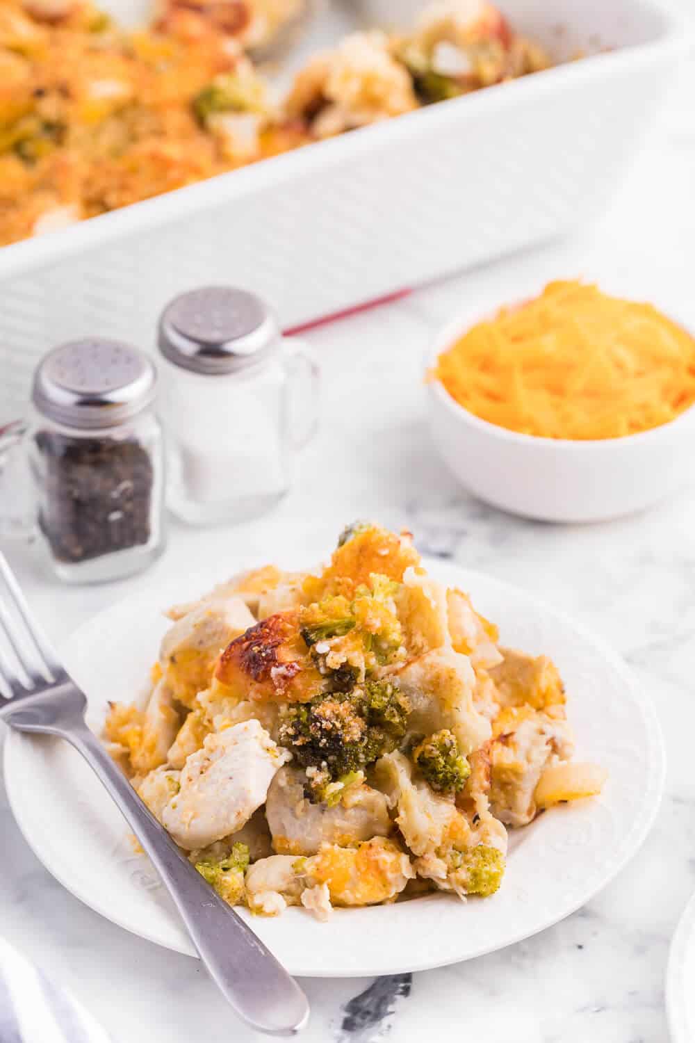 Chicken broccoli biscuit bake served on a white plate with a fork.