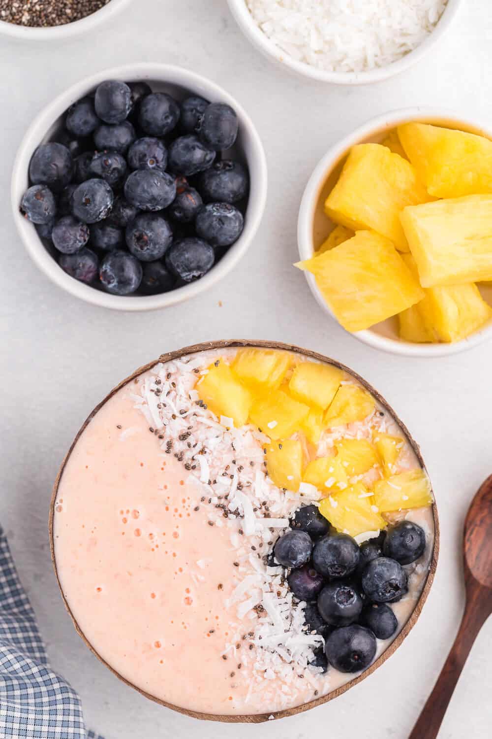 Grapefruit Smoothie Bowl - This easy smoothie bowl recipe is healthy and naturally sweet way to kickstart your mornings. It's made with creamy blend of Sweet Scarletts Texas Red Grapefruit, Greek Yogurt, pineapple and a banana. Top it with some fresh blueberries, seeds and coconut. Yum!