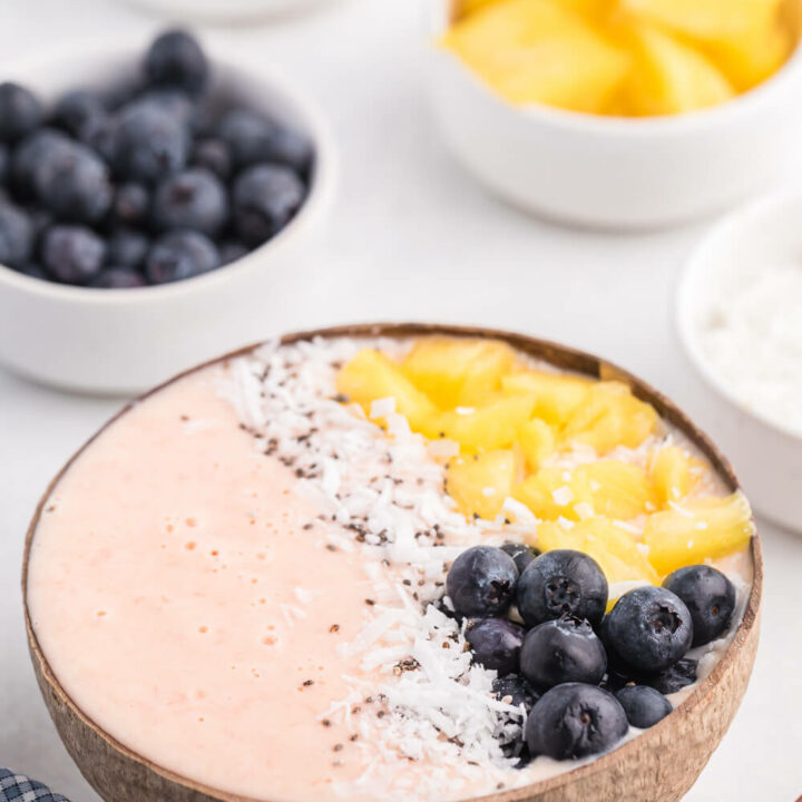 Grapefruit Smoothie Bowl - This easy smoothie bowl recipe is healthy and naturally sweet way to kickstart your mornings. It's made with creamy blend of Sweet Scarletts Texas Red Grapefruit, Greek Yogurt, pineapple and a banana. Top it with some fresh blueberries, seeds and coconut. Yum!