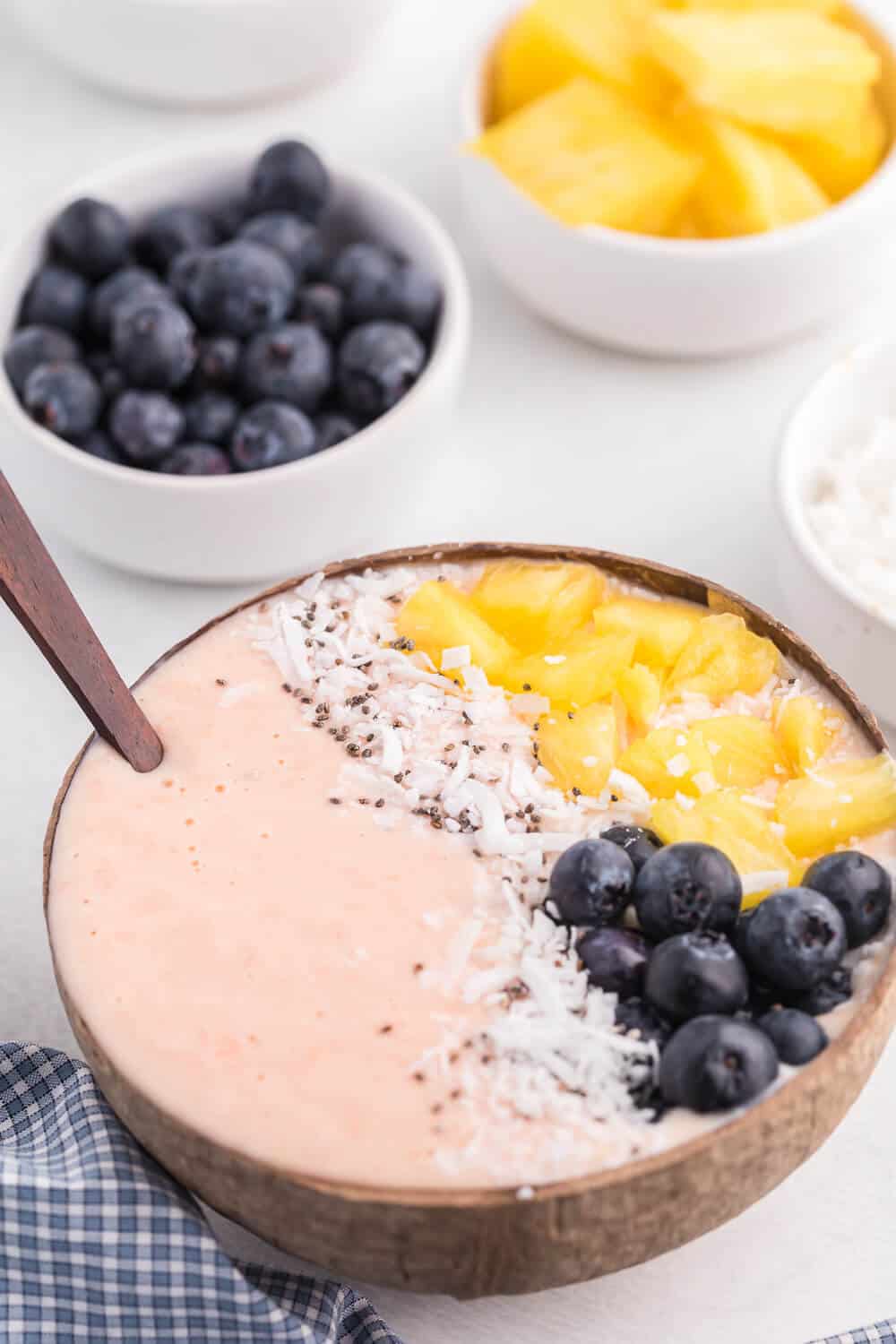 Grapefruit Smoothie Bowl - This easy smoothie bowl recipe is healthy and naturally sweet way to kickstart your mornings. It's made with creamy blend of Sweet Scarletts Texas Red Grapefruit, Greek Yogurt, pineapple and a banana. Top it with some fresh blueberries, seeds and coconut. Yum!