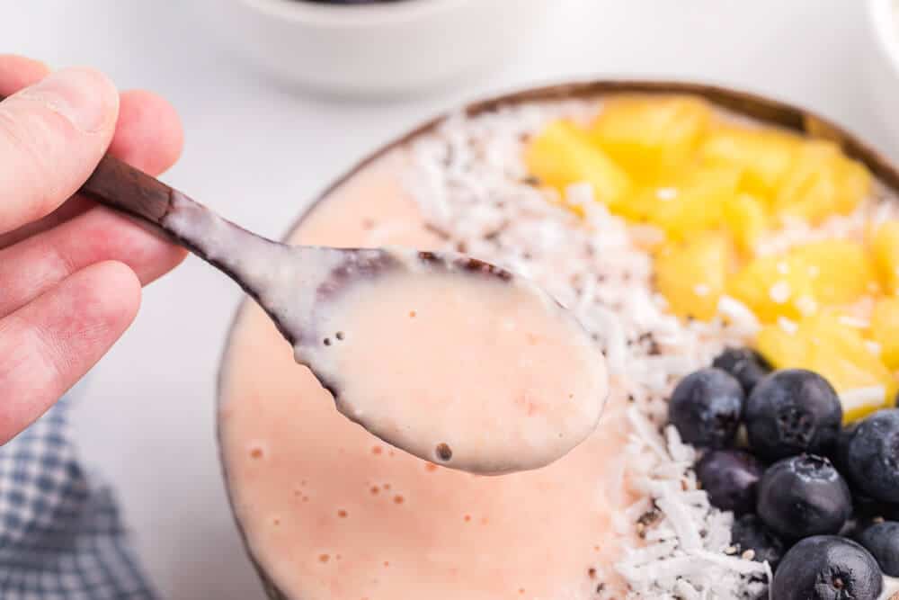 Grapefruit Smoothie Bowl - This easy smoothie bowl recipe is healthy and naturally sweet way to kickstart your mornings. It's made with creamy blend of Sweet Scarletts Texas Red Grapefruit, Greek Yogurt, pineapple and a banana. Top it with some fresh blueberries, seeds and coconut. Yum!