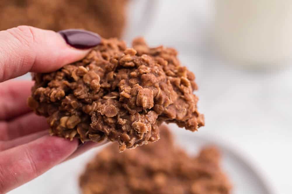 a hand holding a no bake chocolate peanut butter cookies