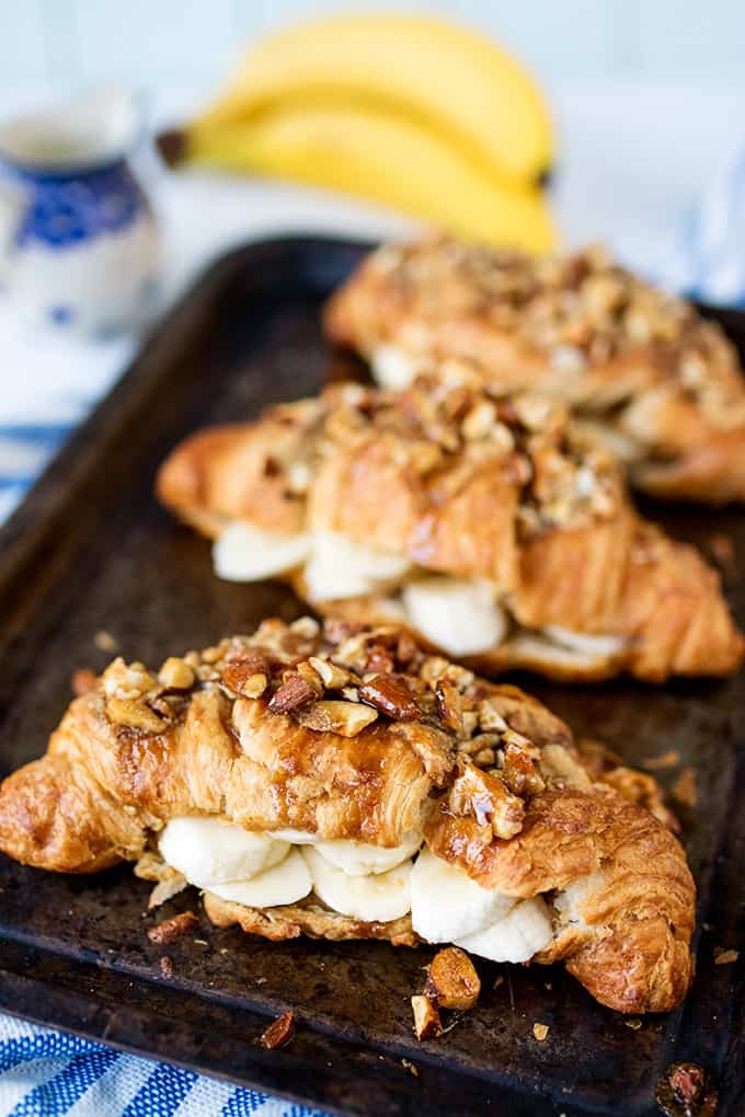 Sticky banana croissants on a baking sheet.