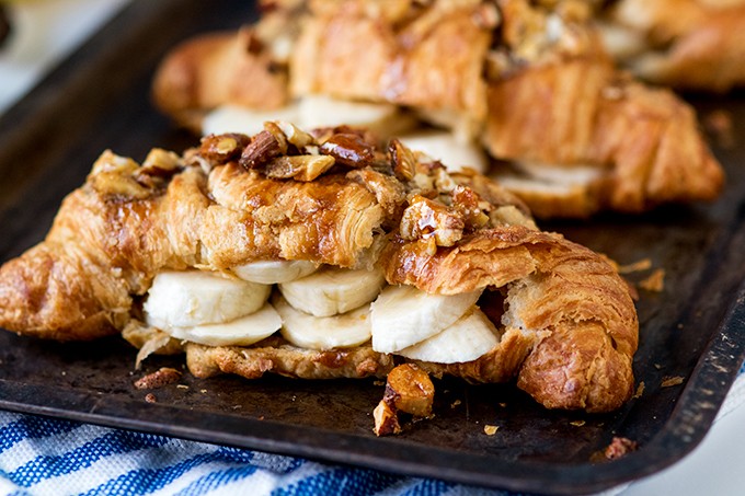 Sticky banana croissants on a baking sheet.