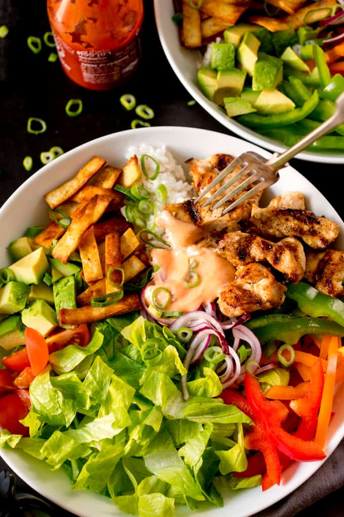 Tex mex lunch bowl with a fork in the bowl.