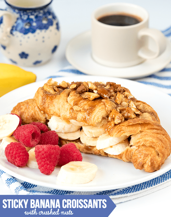 Sticky Banana Croissants with Crushed Nuts - Flaky croissants stuffed with bananas and brown sugar frangipane, then topped with honey-coated nuts. The best Sunday breakfast!