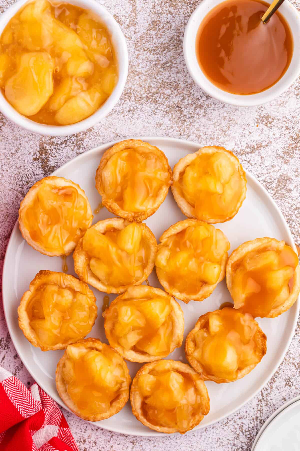 Caramel apple tarts on a plate.