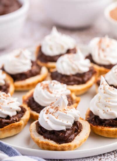 A plate of chocolate cream tarts.