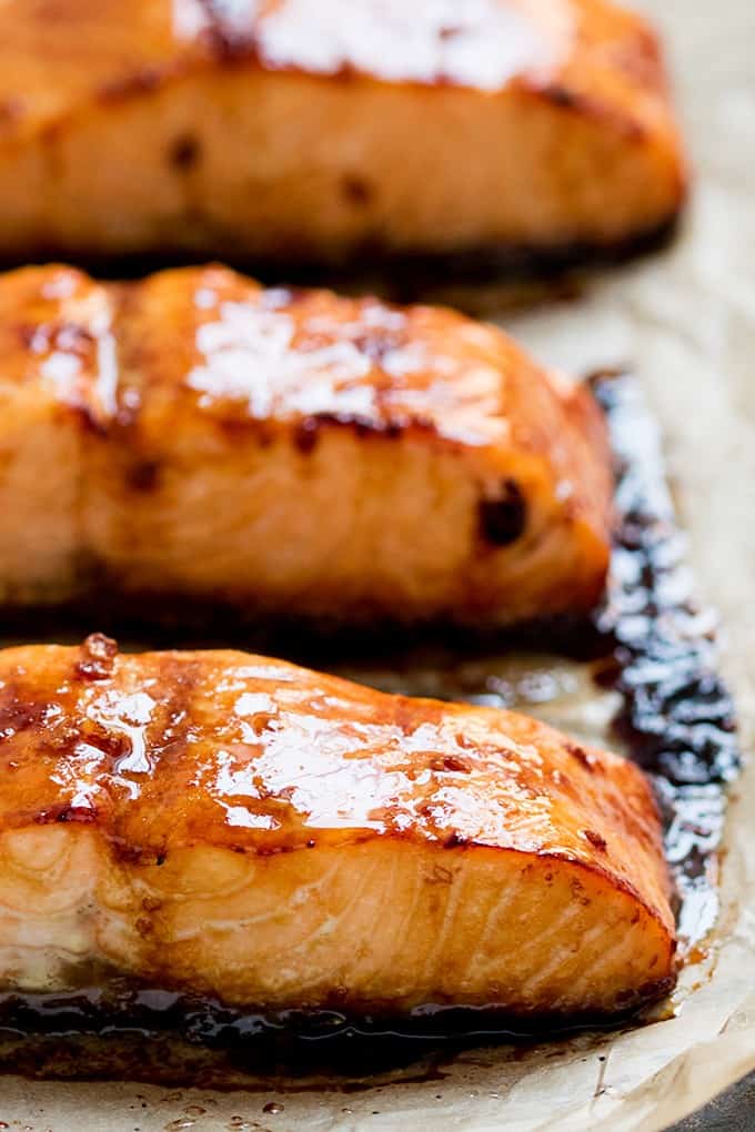 Honey Garlic Baked Salmon - This Asian-inspires salmon dish is as healthy as it is delicious! The simple sesame oil, soy sauce, and honey marinade makes even fish haters love this main dish.