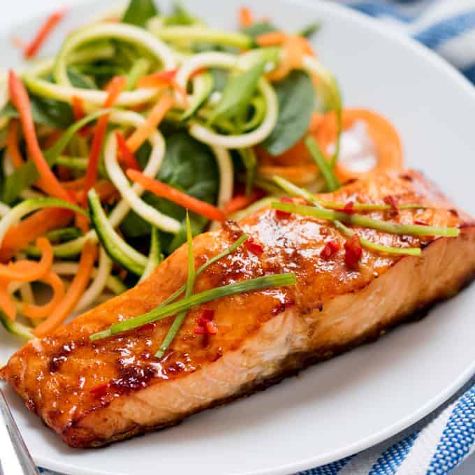 Salmon on a plate with salad.