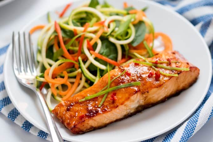 Honey Garlic Baked Salmon - This Asian-inspires salmon dish is as healthy as it is delicious! The simple sesame oil, soy sauce, and honey marinade makes even fish haters love this main dish.