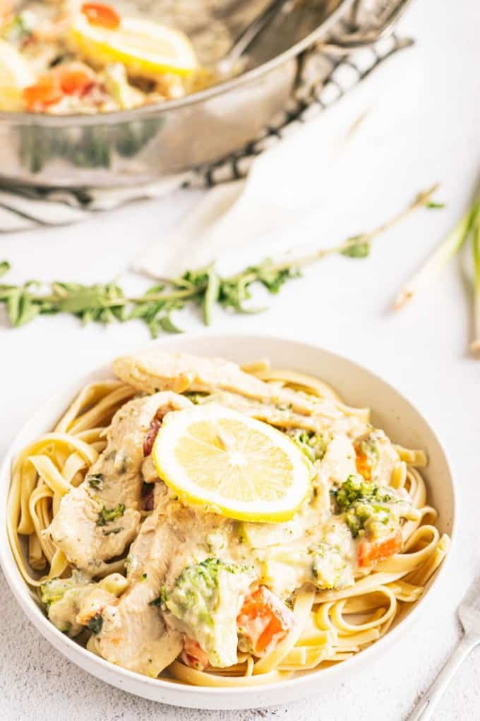 Lemon & Herb Chicken Fettuccine - Your family will love this fresh and healthy springtime meal! Fresh herbs, lemons and chicken in a creamy sauce are served over a bed of fettuccine. Delish!