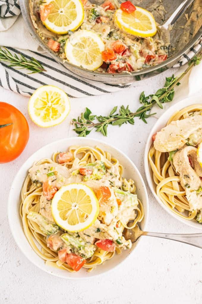 Lemon & Herb Chicken Fettuccine - Your family will love this fresh and healthy springtime meal! Fresh herbs, lemons and chicken in a creamy sauce are served over a bed of fettuccine. Delish!