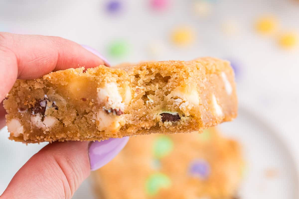 A hand holding a spring cookie bar.