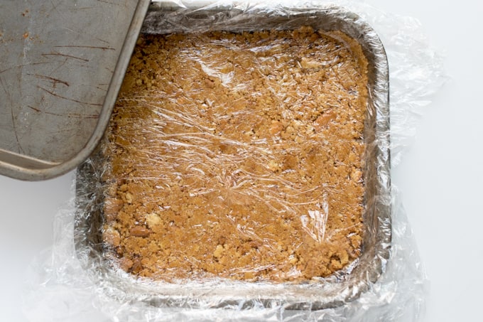Graham cracker crust in a square pan.