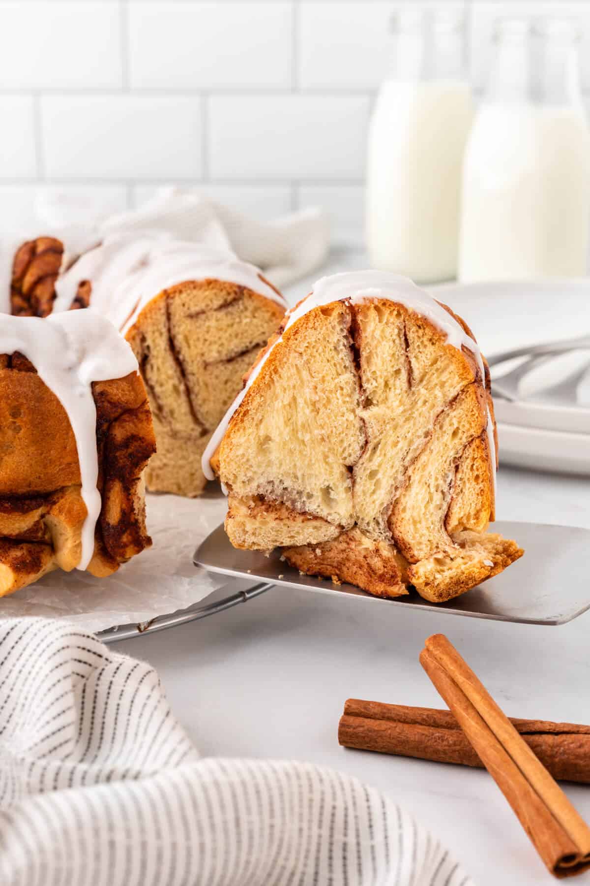 A slice of cinnamon roll monkey bread on a server.