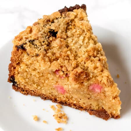 A slice of rhubarb crumble cake on a plate.