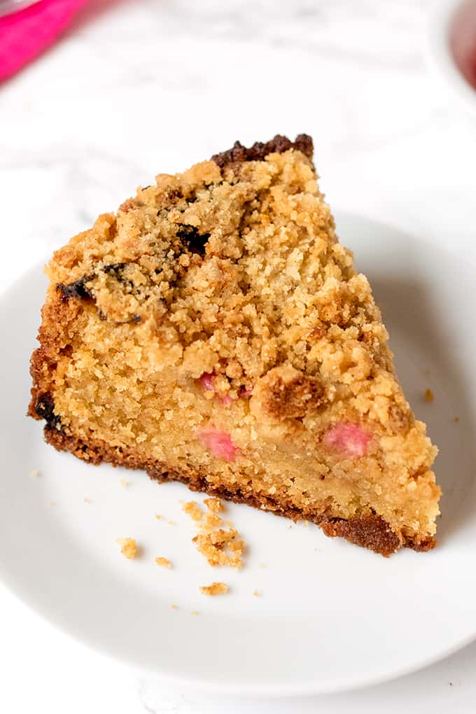 A slice of rhubarb crumble cake on a plate.