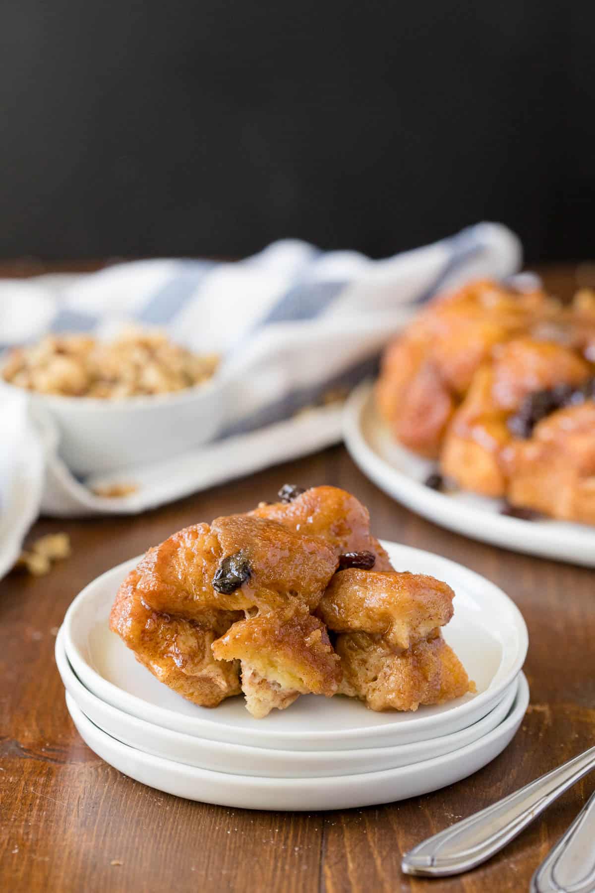 Classic Monkey Bread Recipe - Easy pull-apart bread swimming with walnuts, raisins, and a sweet glaze. Made for breakfast or dessert!