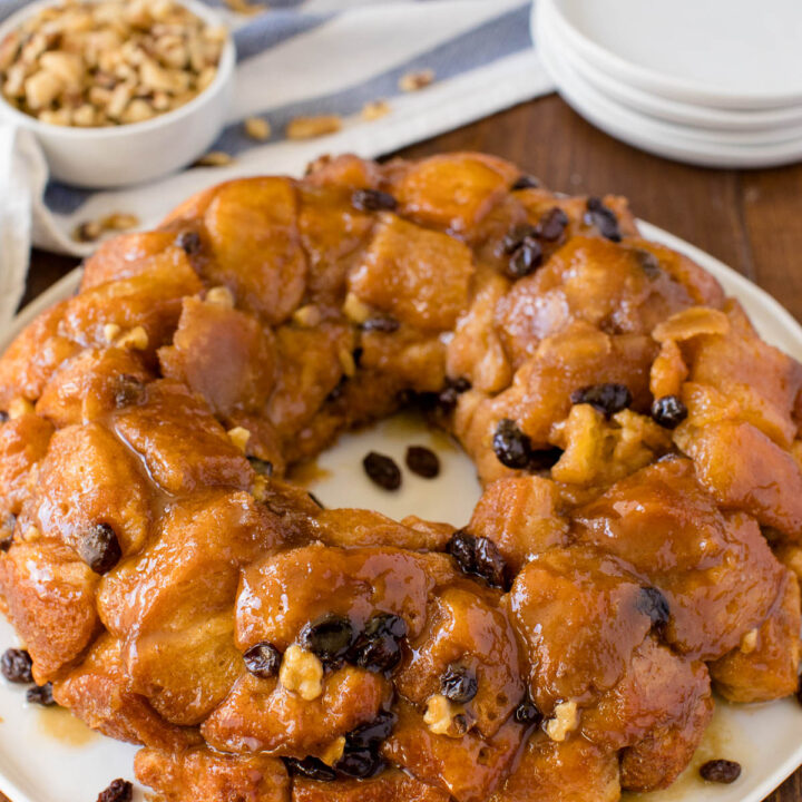 Classic Monkey Bread Recipe - Easy pull-apart bread swimming with walnuts, raisins, and a sweet glaze. Made for breakfast or dessert!