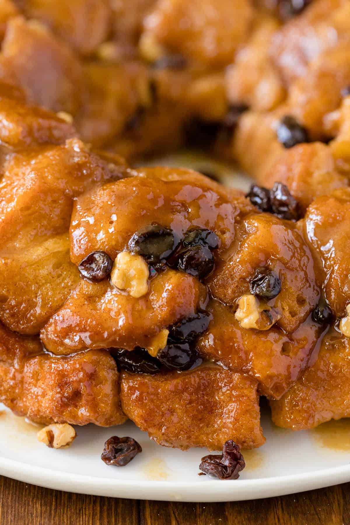 Classic Monkey Bread Recipe - Easy pull-apart bread swimming with walnuts, raisins, and a sweet glaze. Made for breakfast or dessert!