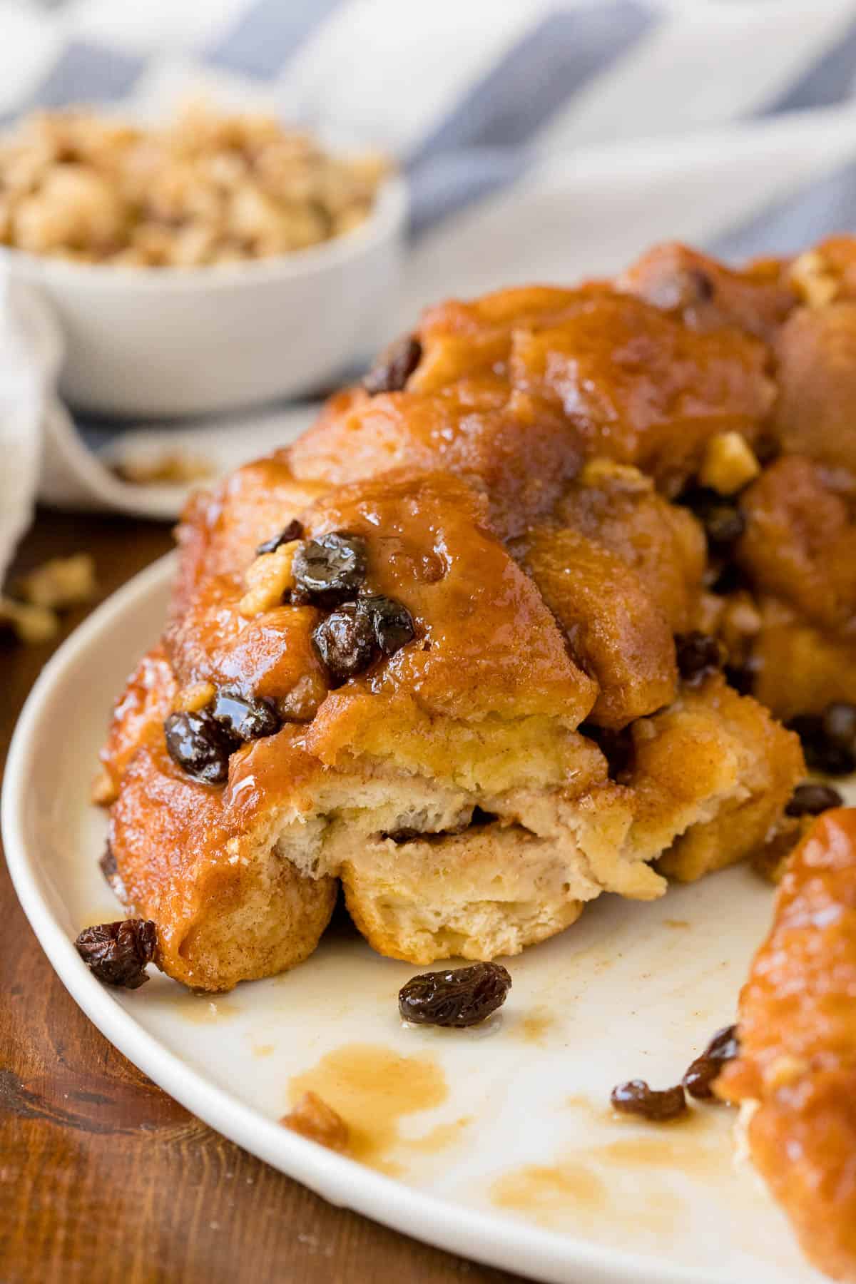 Classic Monkey Bread Recipe - Easy pull-apart bread swimming with walnuts, raisins, and a sweet glaze. Made for breakfast or dessert!