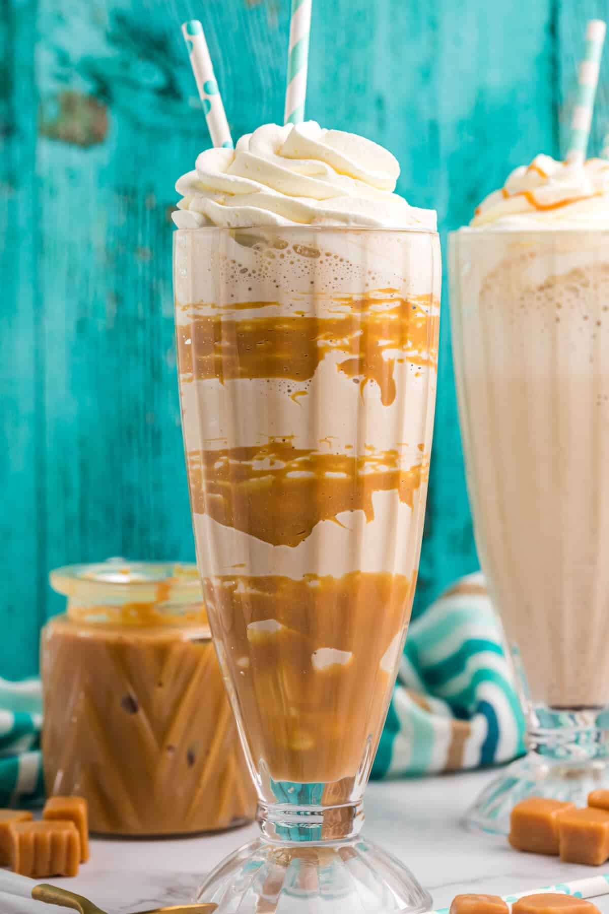 A dulce de leche coffee milkshake with two straws.