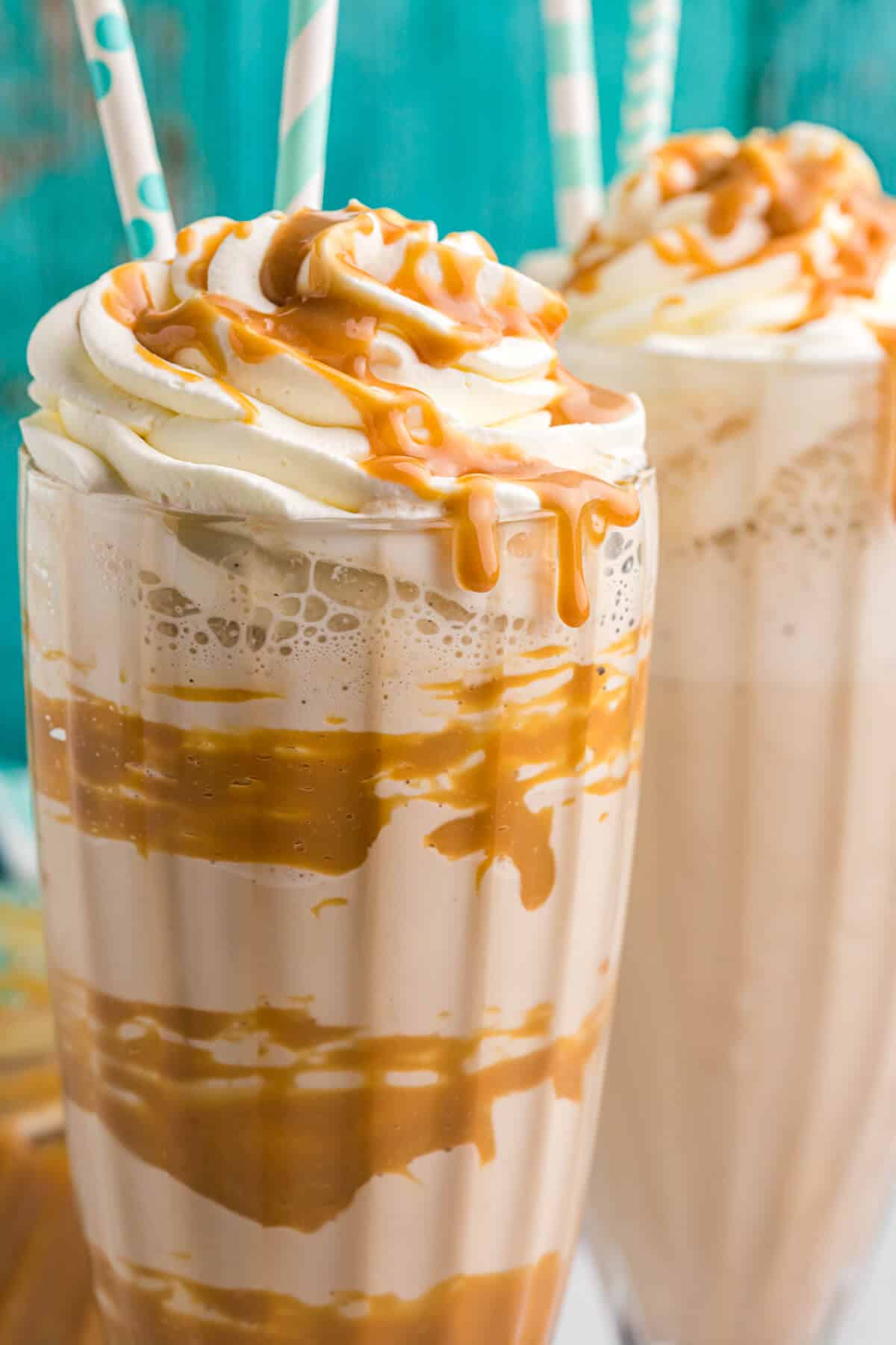 A dulce de leche coffee milkshake with two straws.