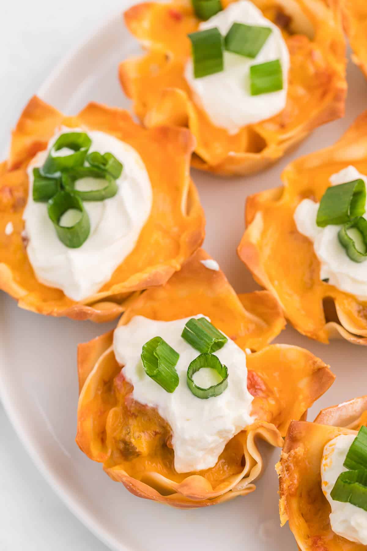 Up close photo of taco wonton cups on a plate