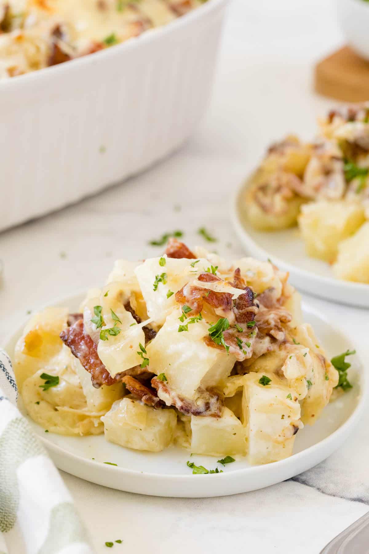 Bacon ranch potatoes served on a white plate.