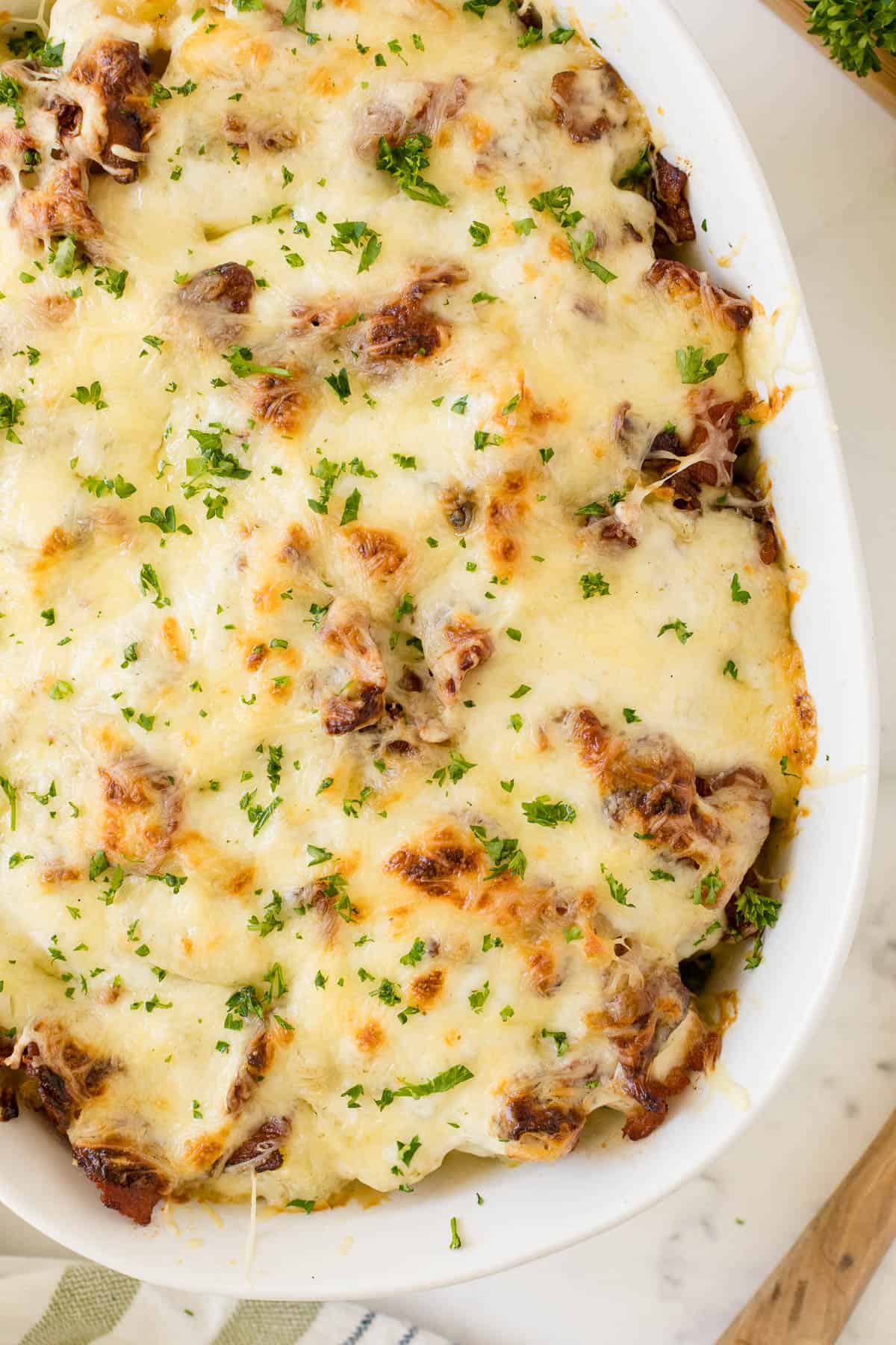 Bacon ranch potatoes in a white casserole dish.