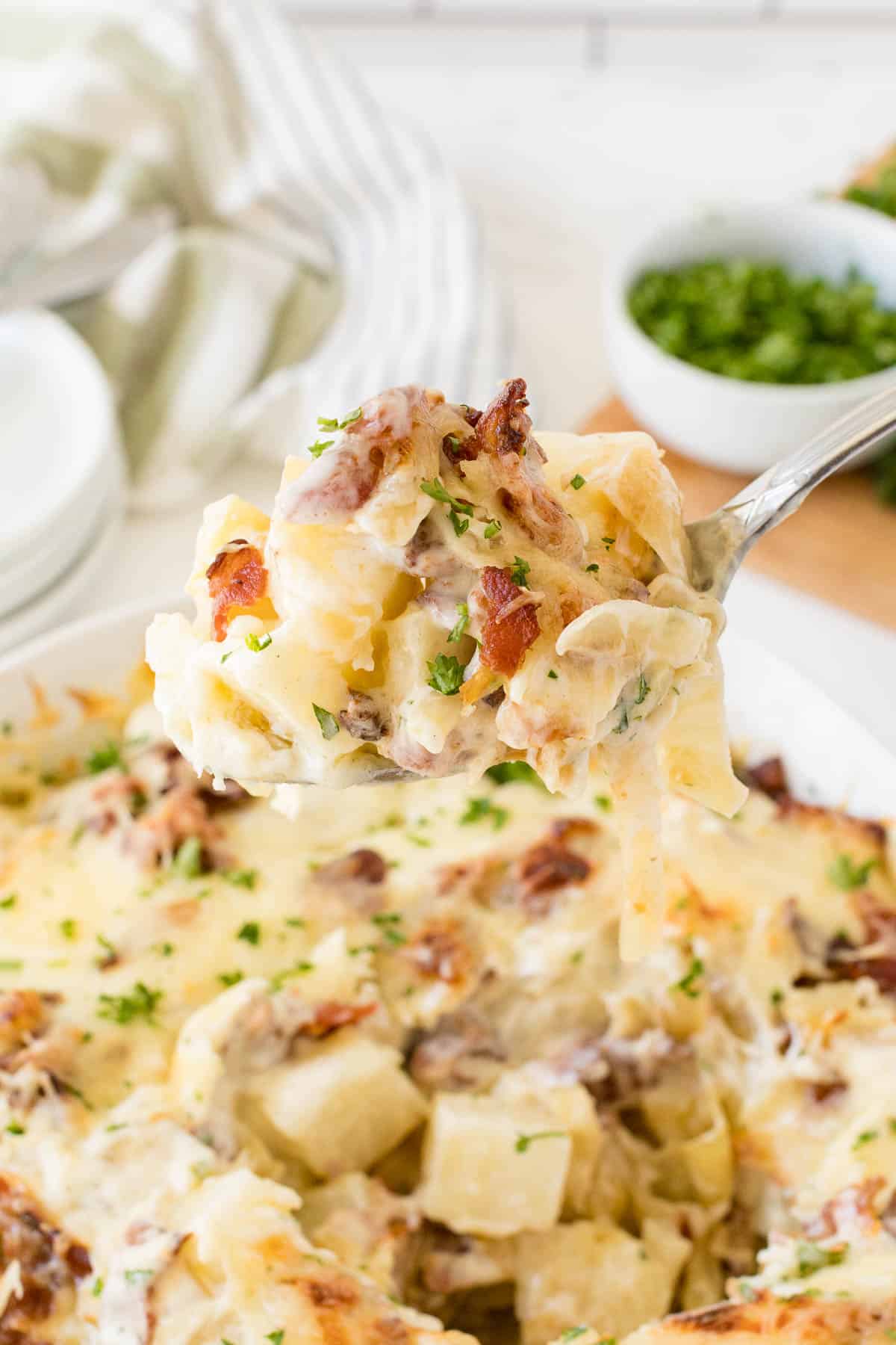 Bacon ranch potatoes on a serving spoon.