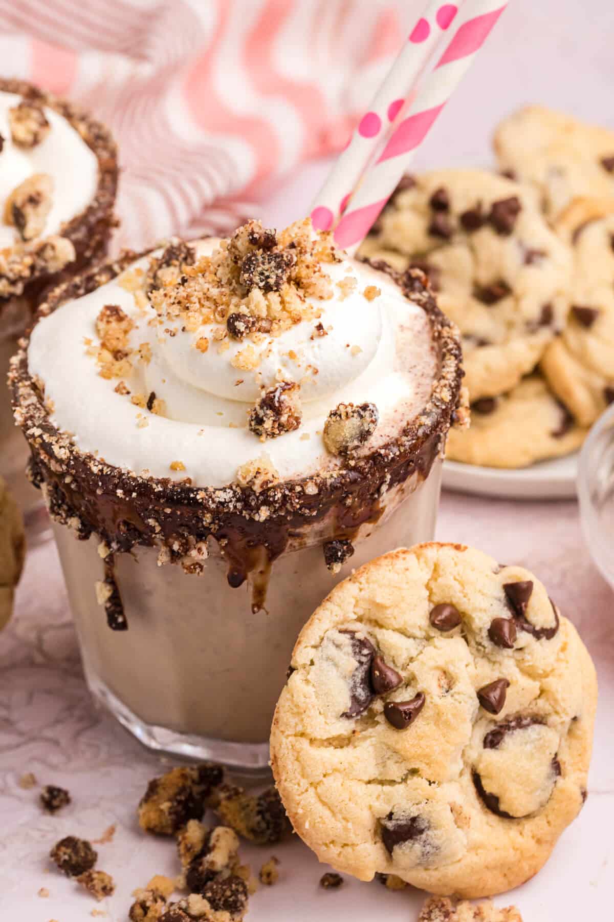 Chocolate chip cookie coffee milkshake with a cookie beside it.