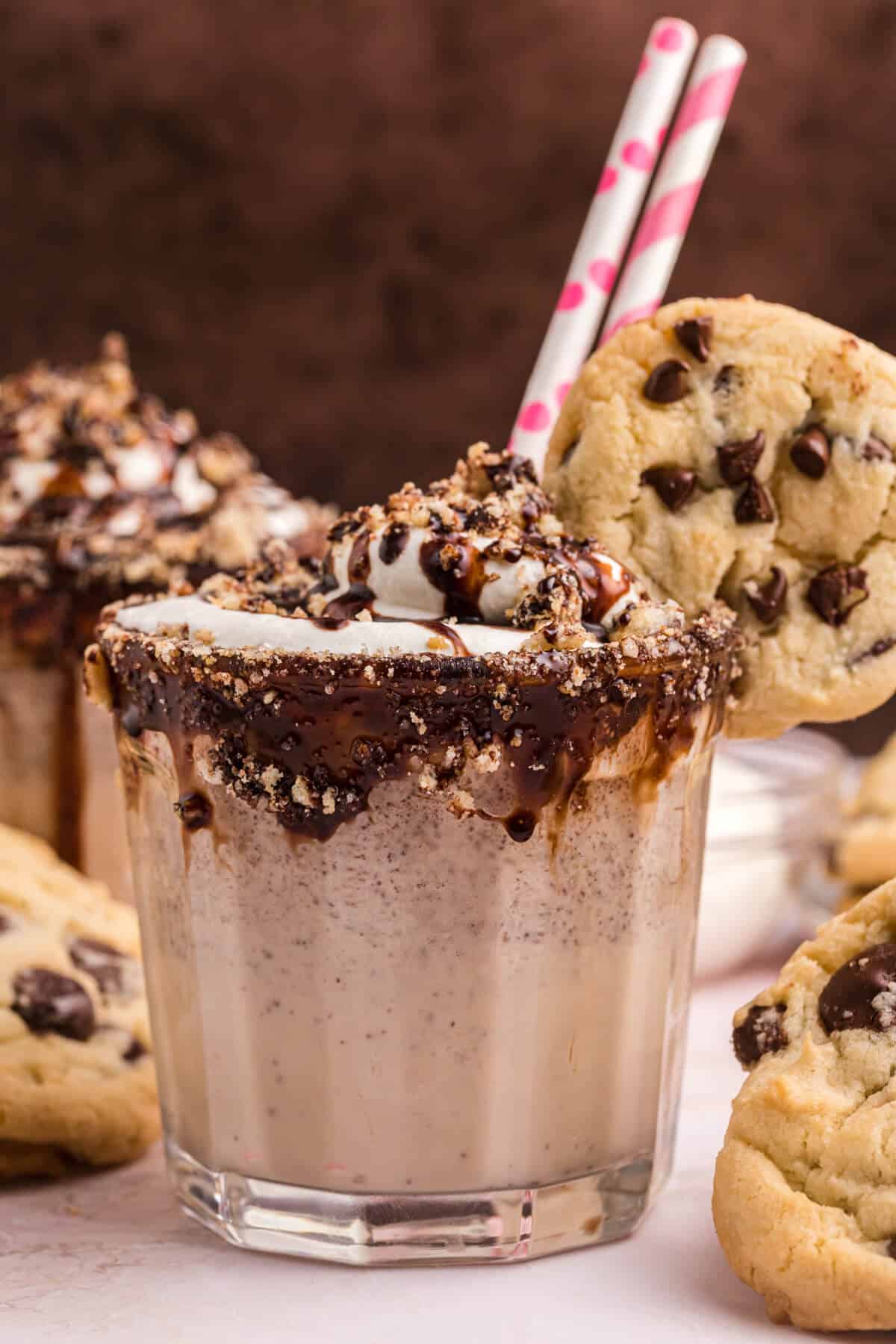 Chocolate chip cookie coffee milkshake with a straw.