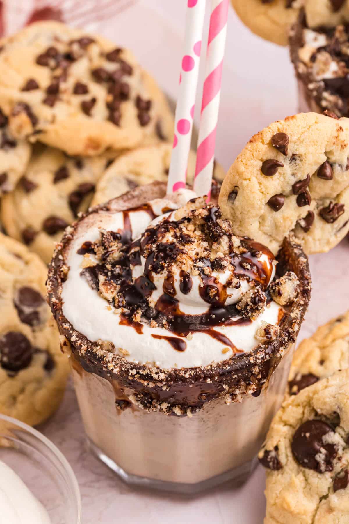 Chocolate chip cookie coffee milkshake with straws.